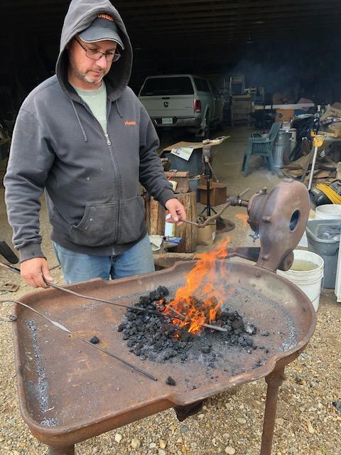 Ian Bugera of Beaver Branches using a forge to create metal products